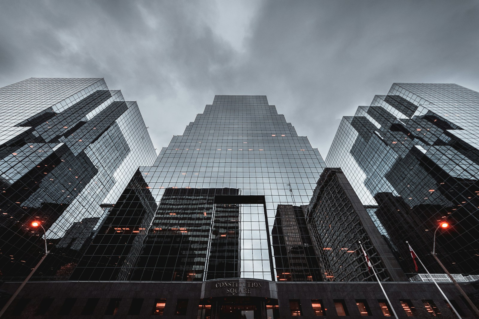 Upward view of tall buildings showing facade lines and structural rhythm.