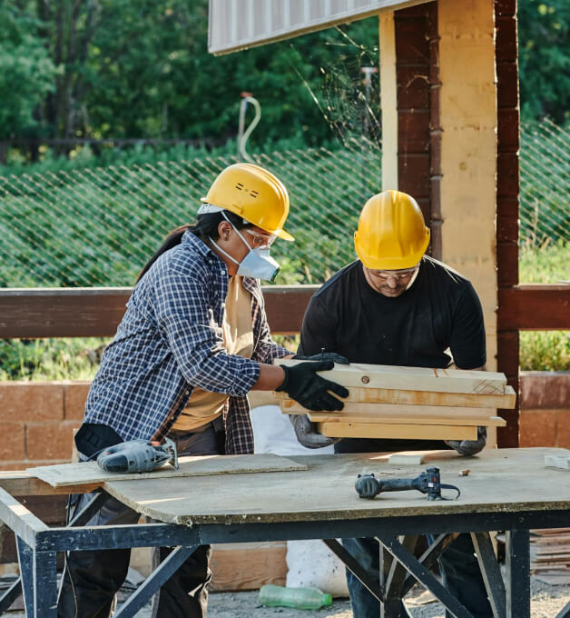 Illustrative construction workers preparing a timber detail.